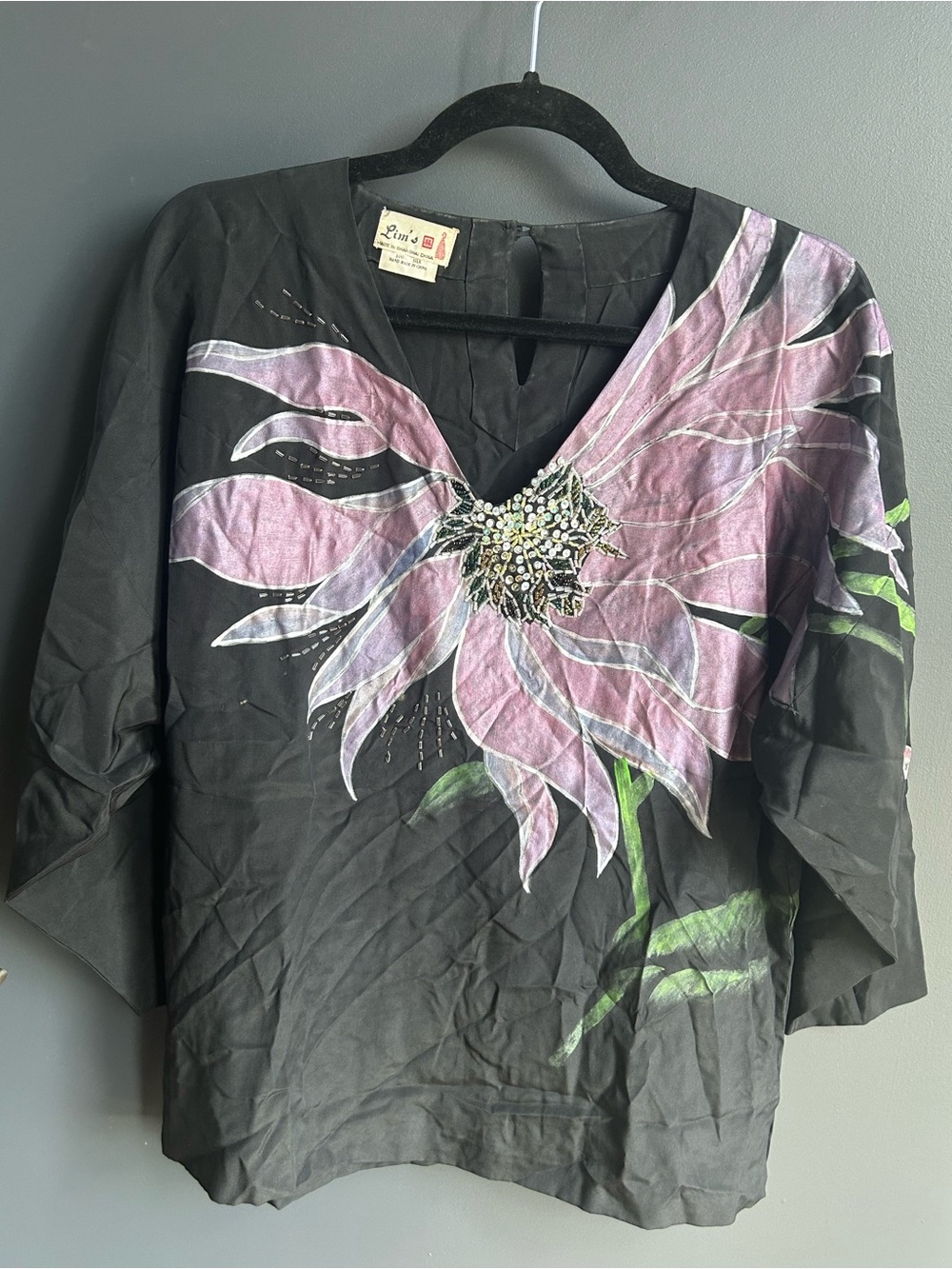 Embellished Black V-Neck Blouse with Pink Floral Motif